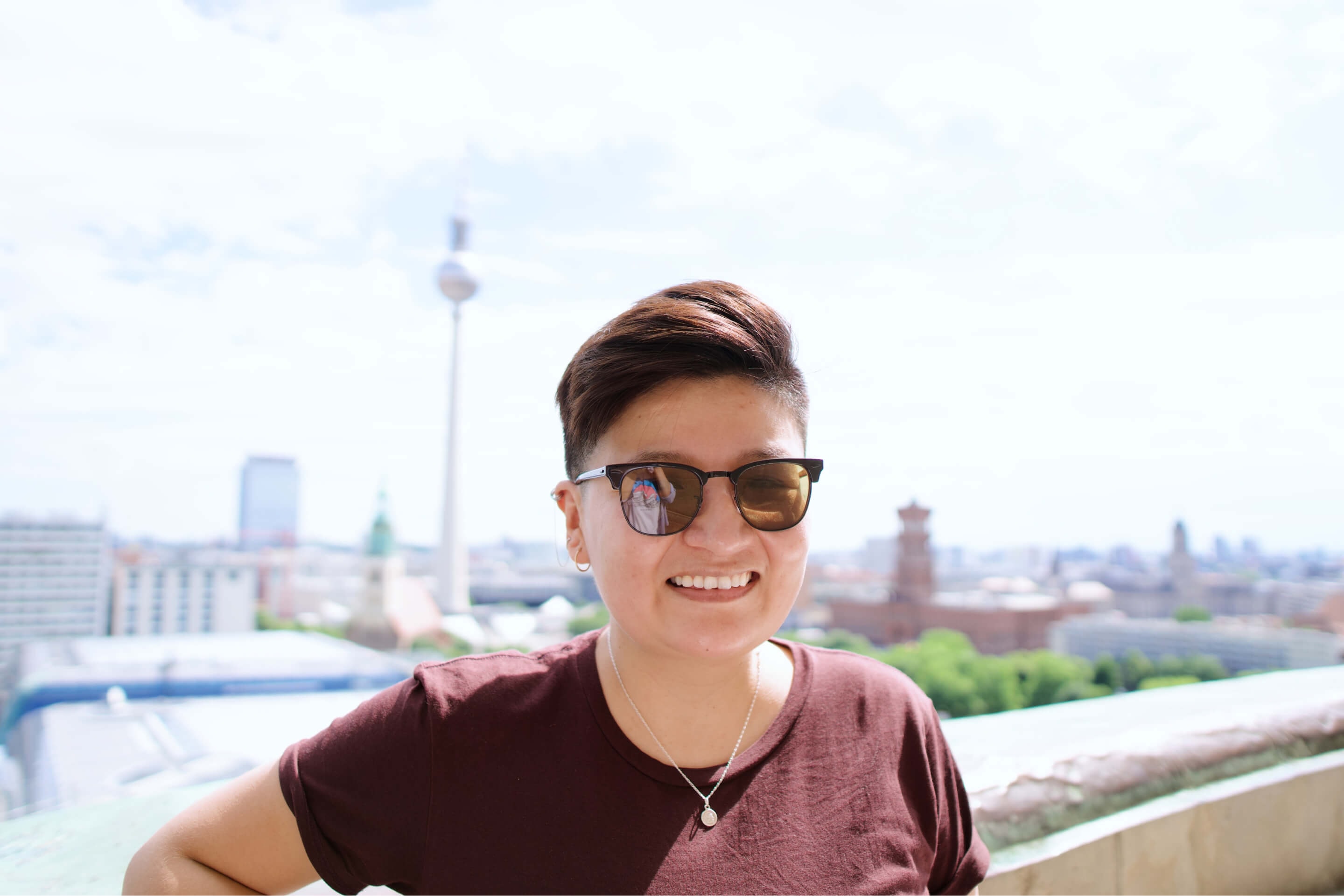 Eli Manrique close up photo with a background of the Berlin City